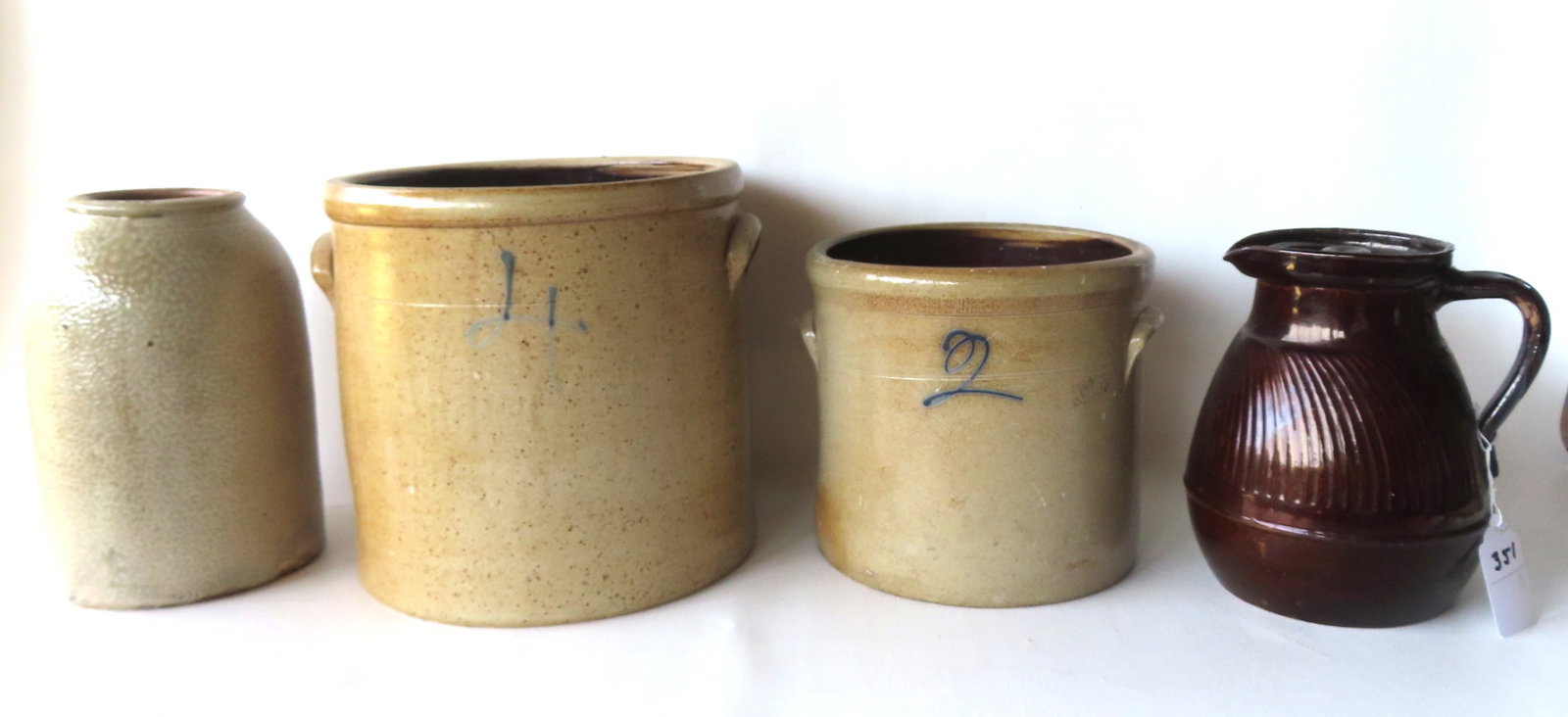 Four stoneware crocks/jugs. Most in very good condition. See photos for further information. The: Four stoneware crocks/jugs. Most in very good condition. See photos for further information. The largest?.