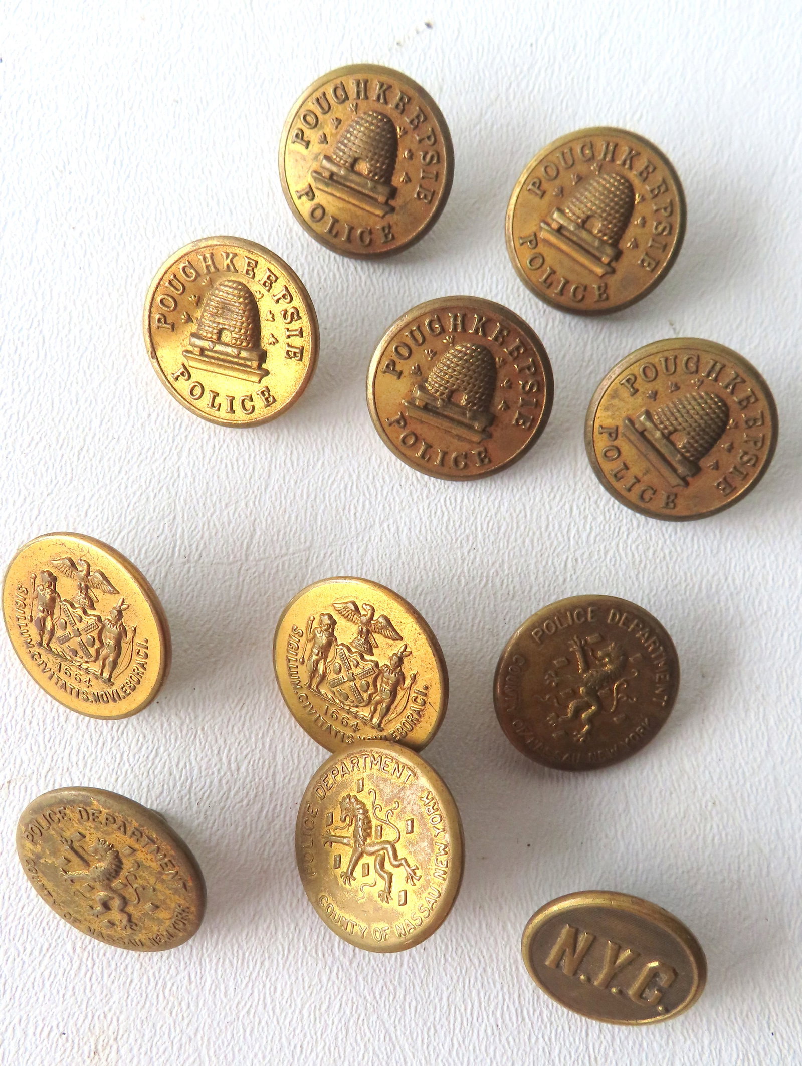 Grouping of 11 early buttons including: "Waterbury Button Co. / Poughkeepsie Police" - 5 buttons; NY (1 of 9)