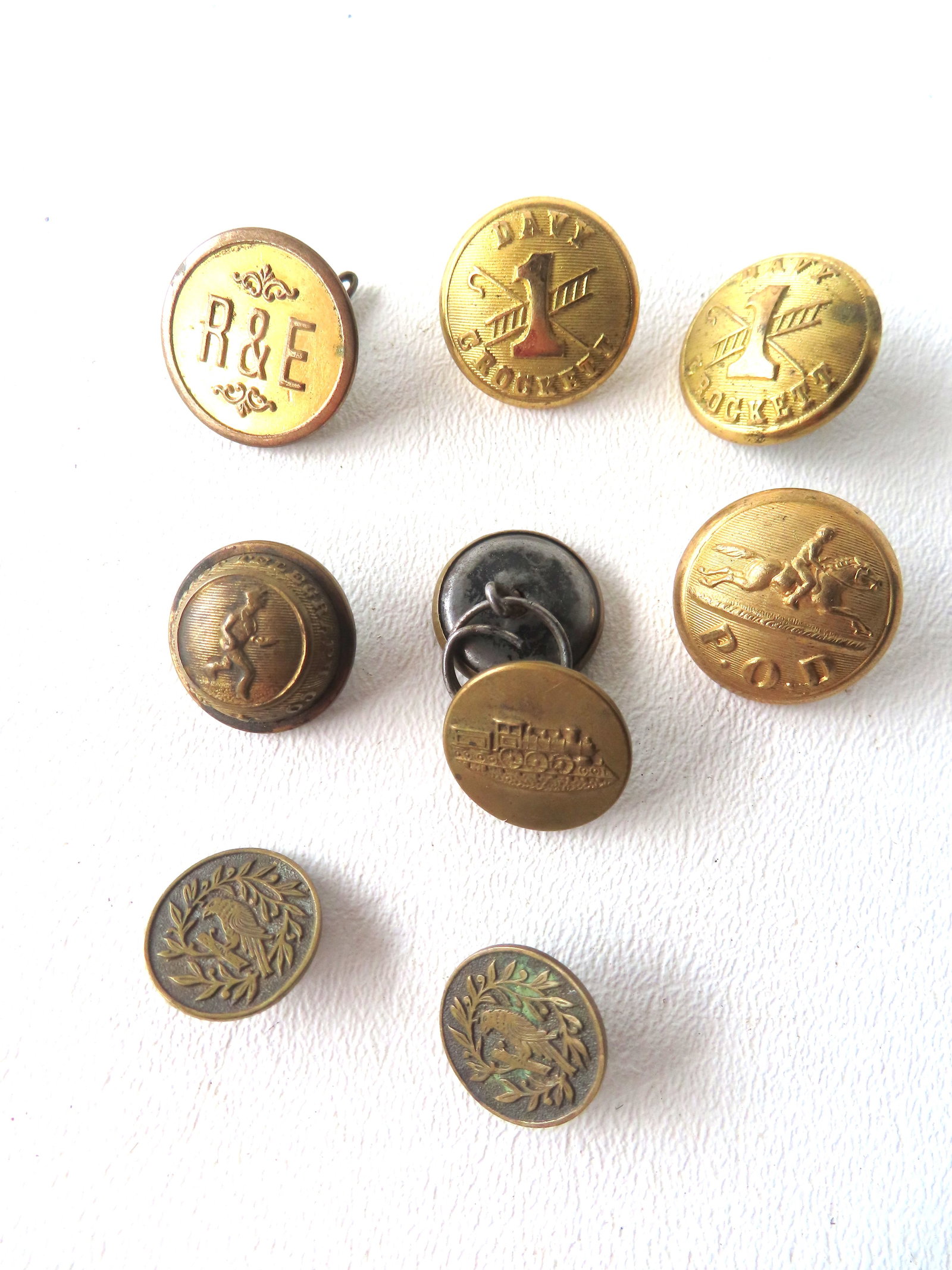 Grouping of 9 Railroad, Firehouse, Post office, & telegraph unform buttons including: "R & E" button (1 of 9)