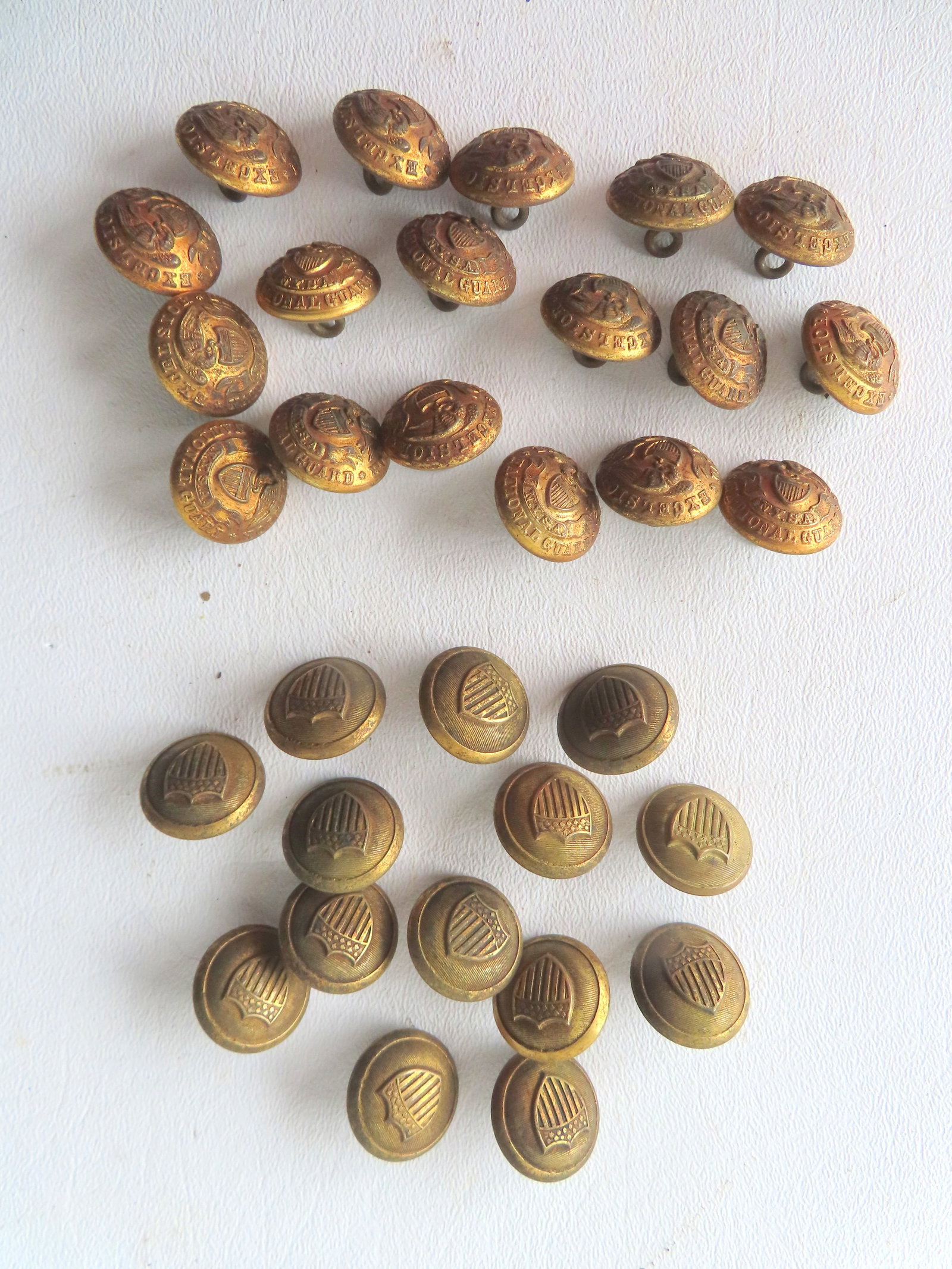 Grouping of 32 military buttons including: 18 brass buttons eagle holding American shield in beak (1 of 7)