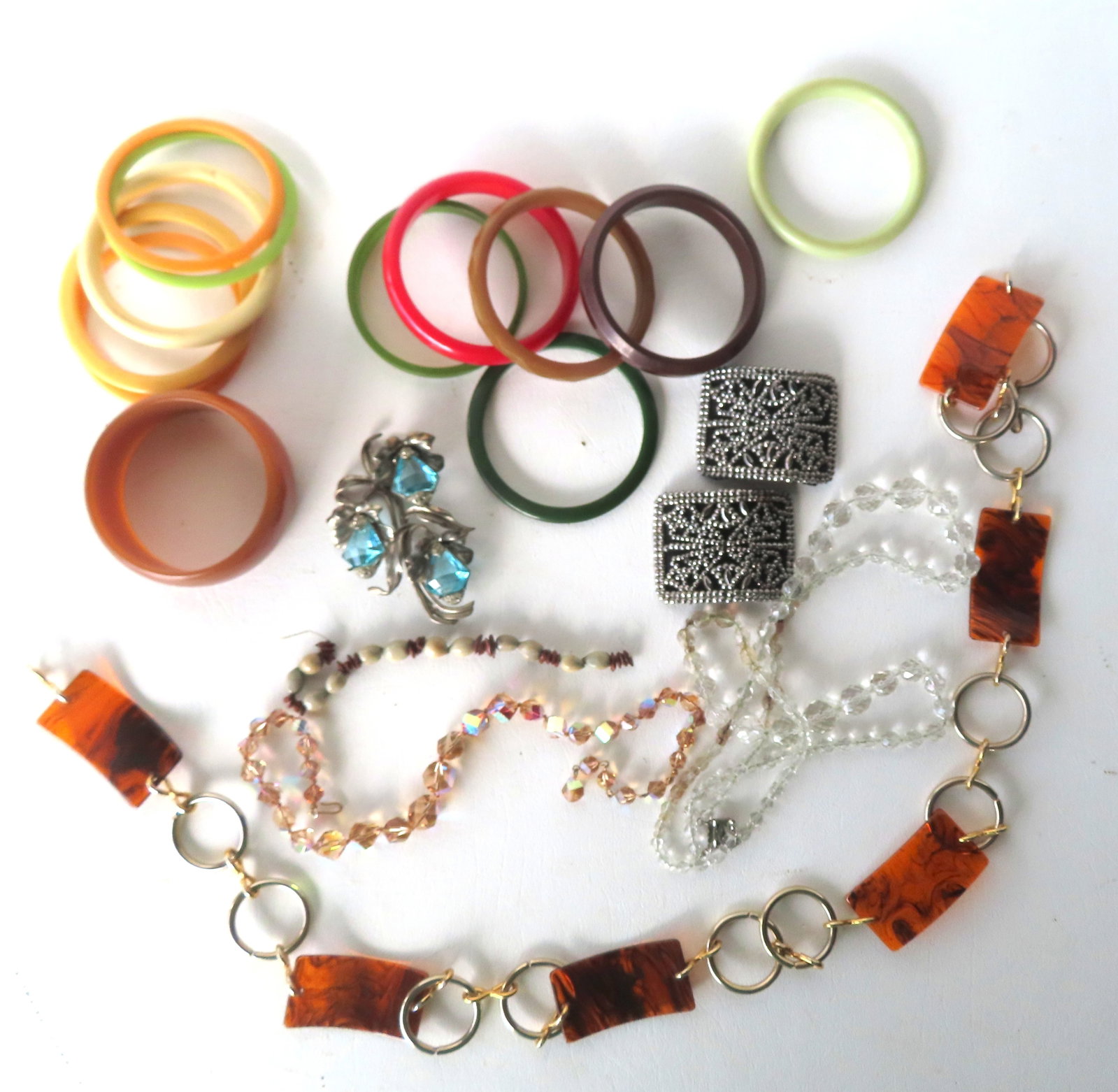 A grouping of 12 Bakolite (some may be plastic) bangle bracelets - one white bracelet with hairline, (1 of 12)