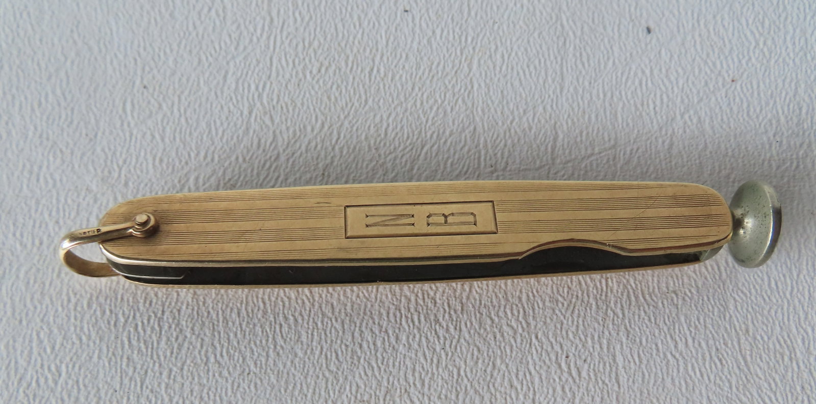 A Cartier 14K gold combination tobacco knife and pipe tamper. Missing blades. Measures xx and weighs (1 of 4)
