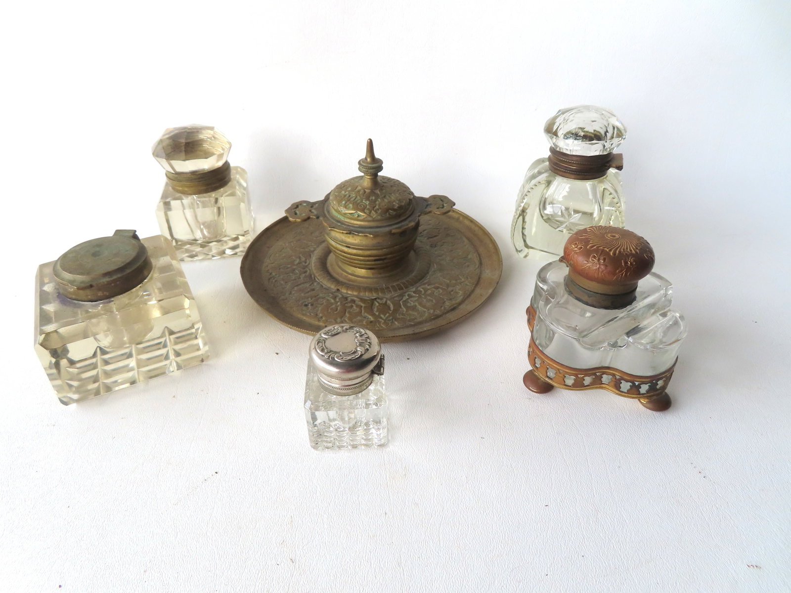 A grouping of 6 vintage inkwells with hinged lids, including: Four inkwells in cut glass and 1 in (1 of 9)
