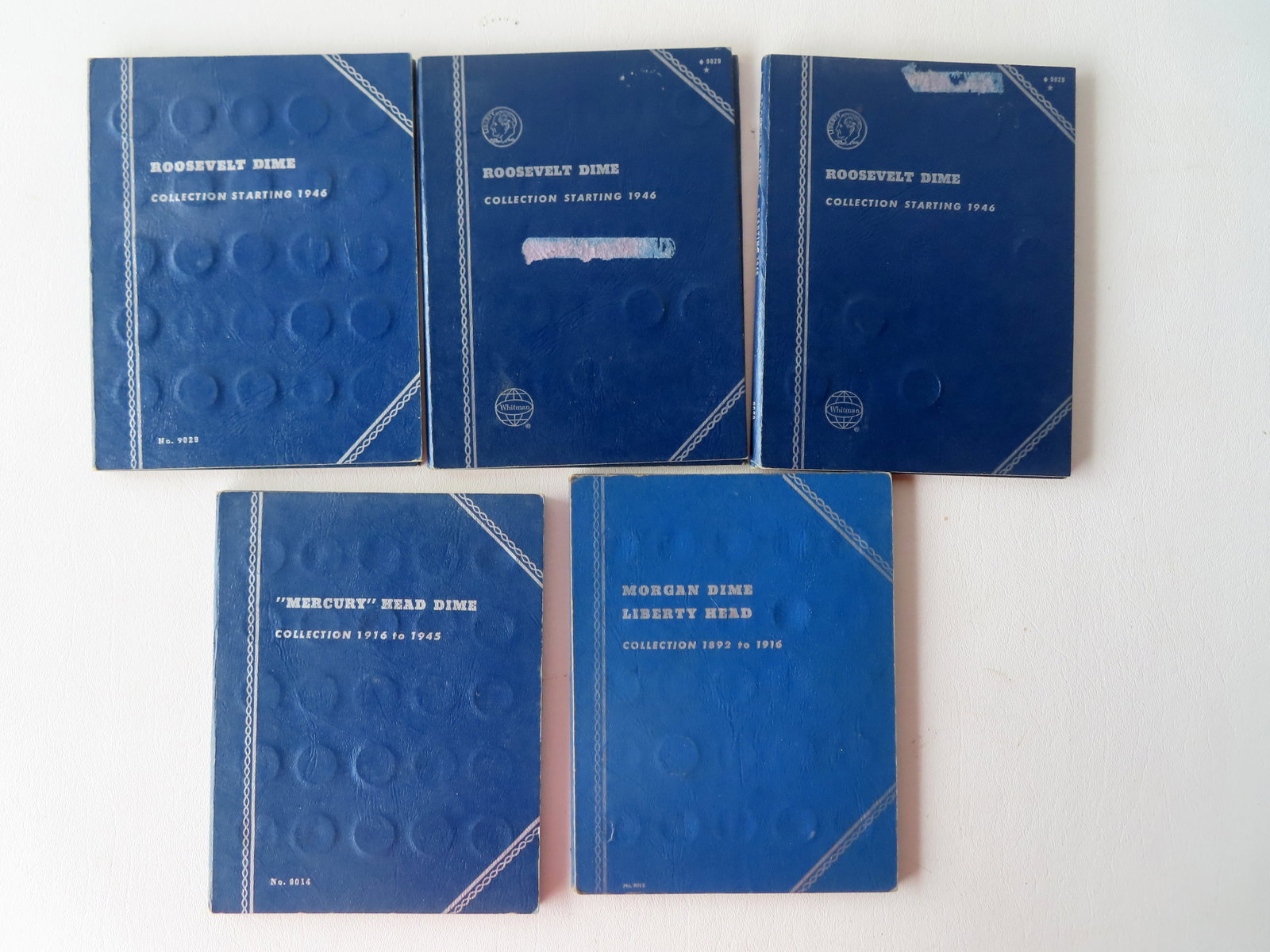A grouping of 184 American Mercury Head, Morgan Liberty Head, and Roosevelt dimes, housed in 5: A grouping of 184 American Mercury Head, Morgan Liberty Head, and Roosevelt dimes, housed in 5 collector's books, all incomplete. Includes Mercury Head Dimes Collection 1916-1945 containing 66 dimes; 