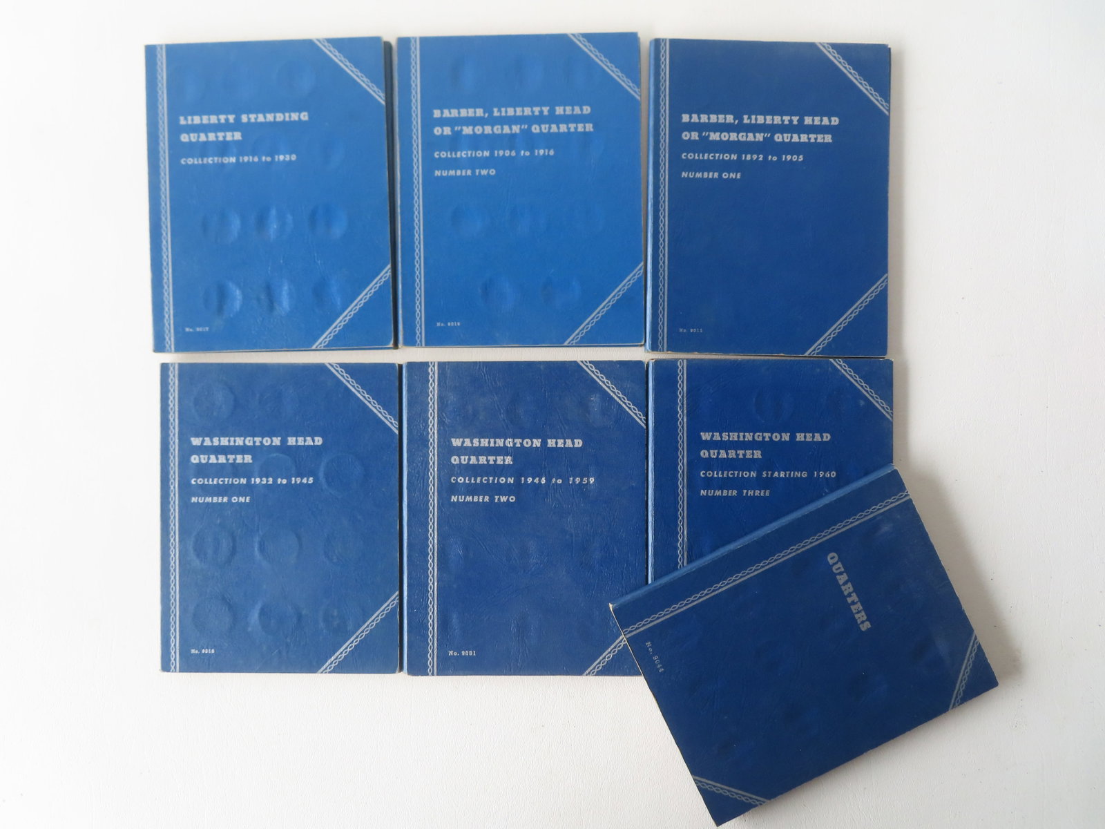 A grouping of 120 American silver quarters housed in 7 collector booklets, including Liberty (1 of 17)