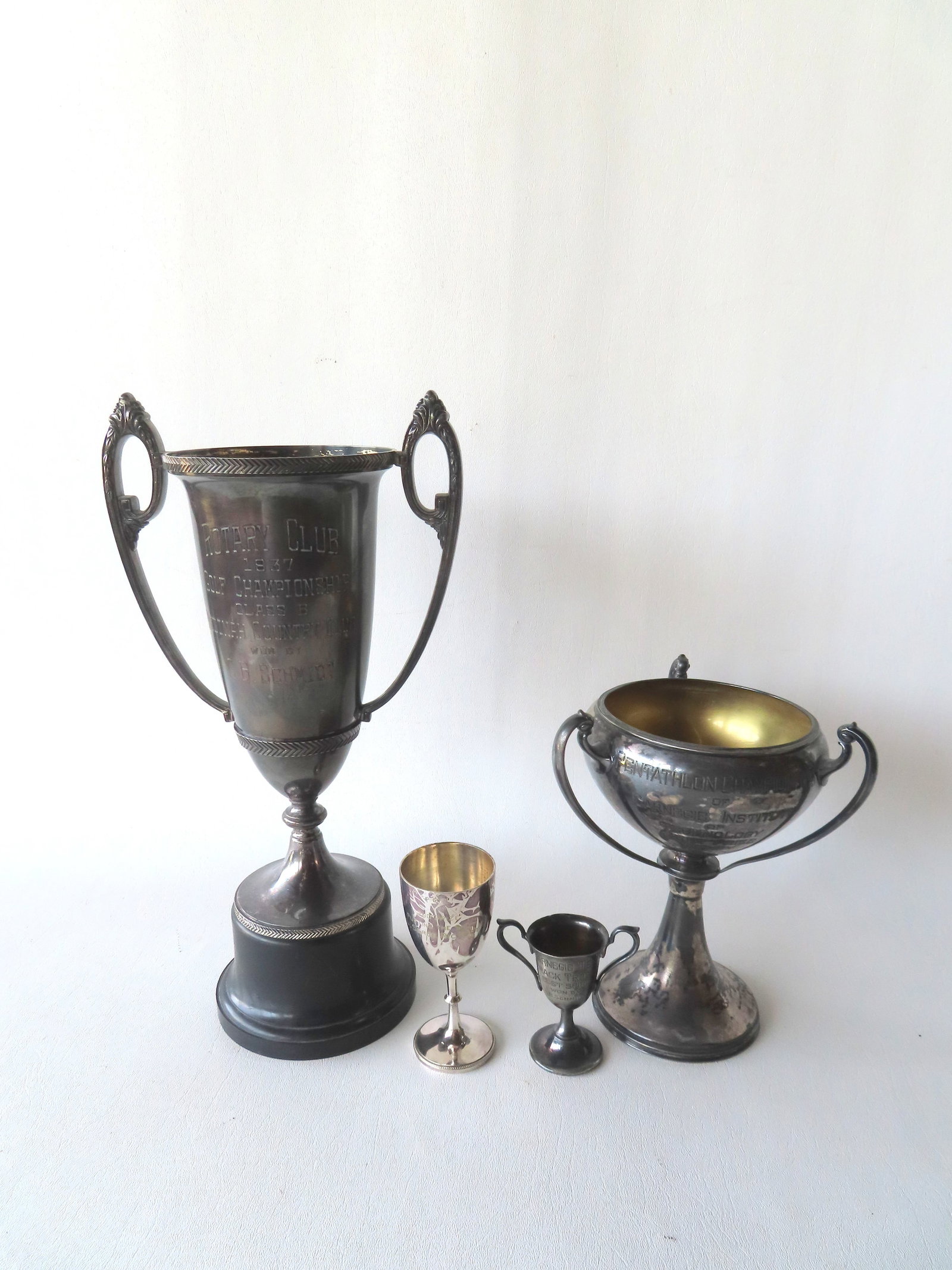 Grouping of 4 silver plated loving cups, 2 golf related, and 2 track and field related. See photos (1 of 5)
