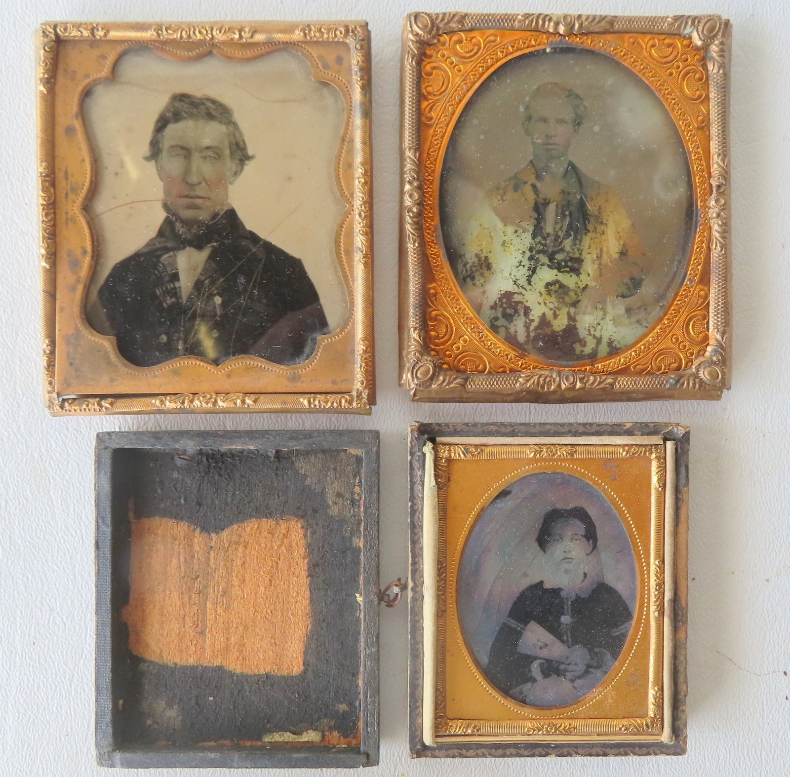 Three ambrotypes, all with losses and damage including: Portrait of lady who appears to be holding a (1 of 2)