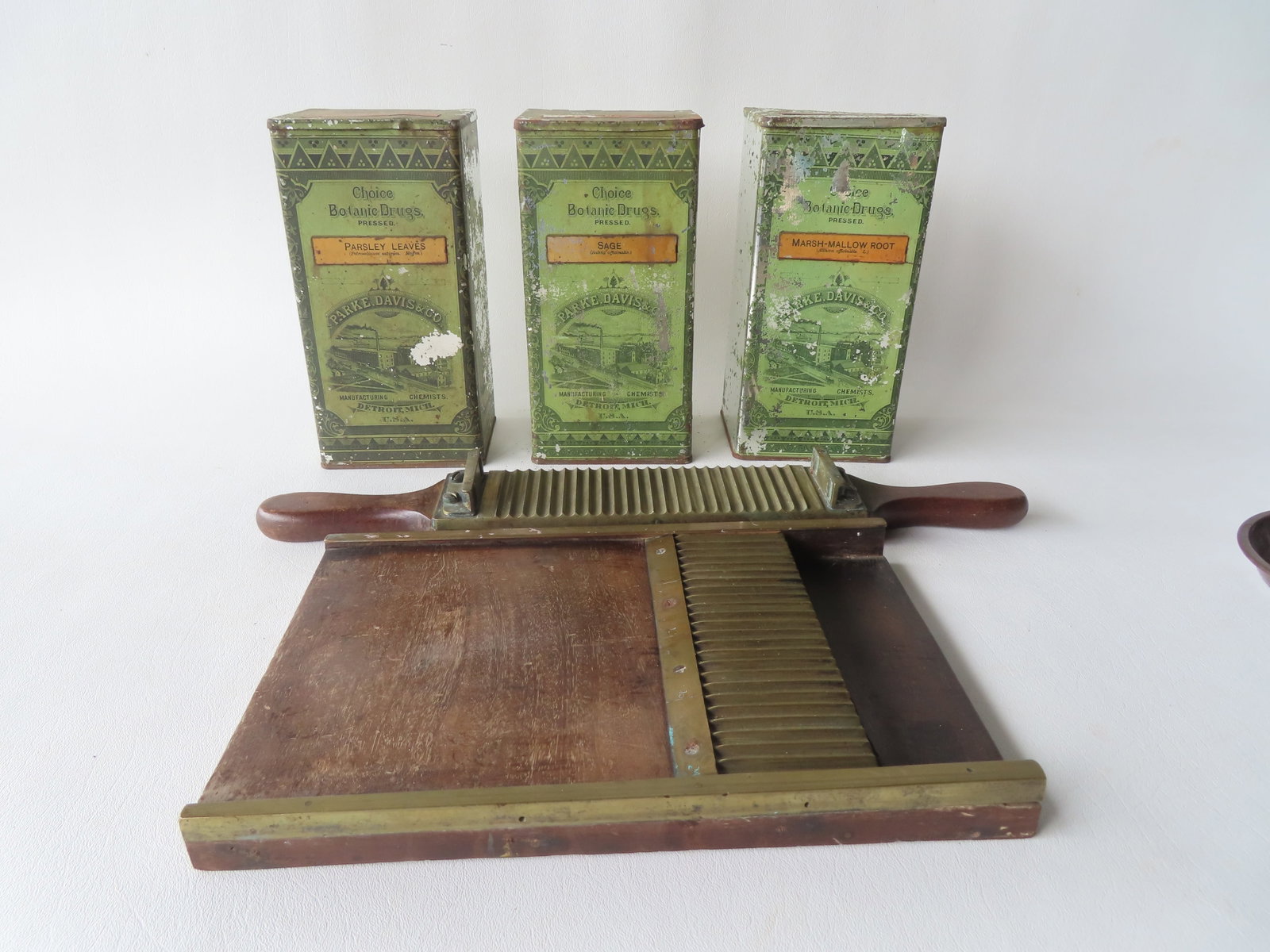 Three apothecary related tins and a Victorian walnut and brass apothecary pill maker's machine, late: Three apothecary related tins and a Victorian walnut and brass apothecary pill maker's machine, late 19th century - expansion crack in base board, otherwise good condition in working order - the large