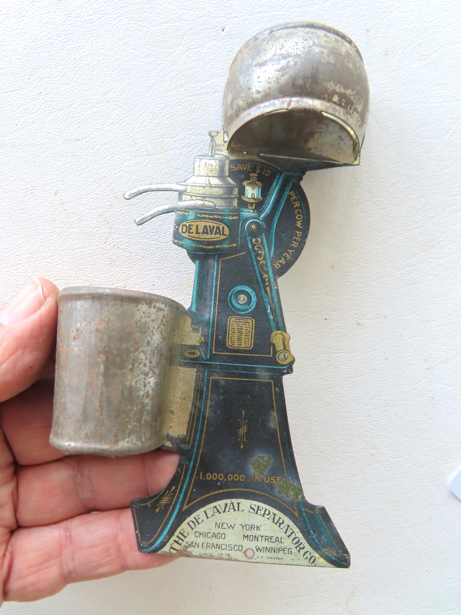 A match safe in the form of a tin advertising of a De Laval cream separator machine, original: A match safe in the form of a tin advertising of a De Laval cream separator machine, original lithograph surface with some use wear but overall good condition, late 19th to early 20th century. Measure