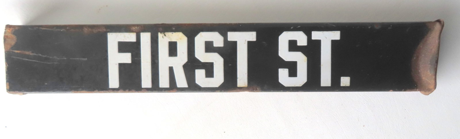 A double sided sheet iron street sign, lettering in white enamel marked "FIRST ST." - losses along (1 of 6)