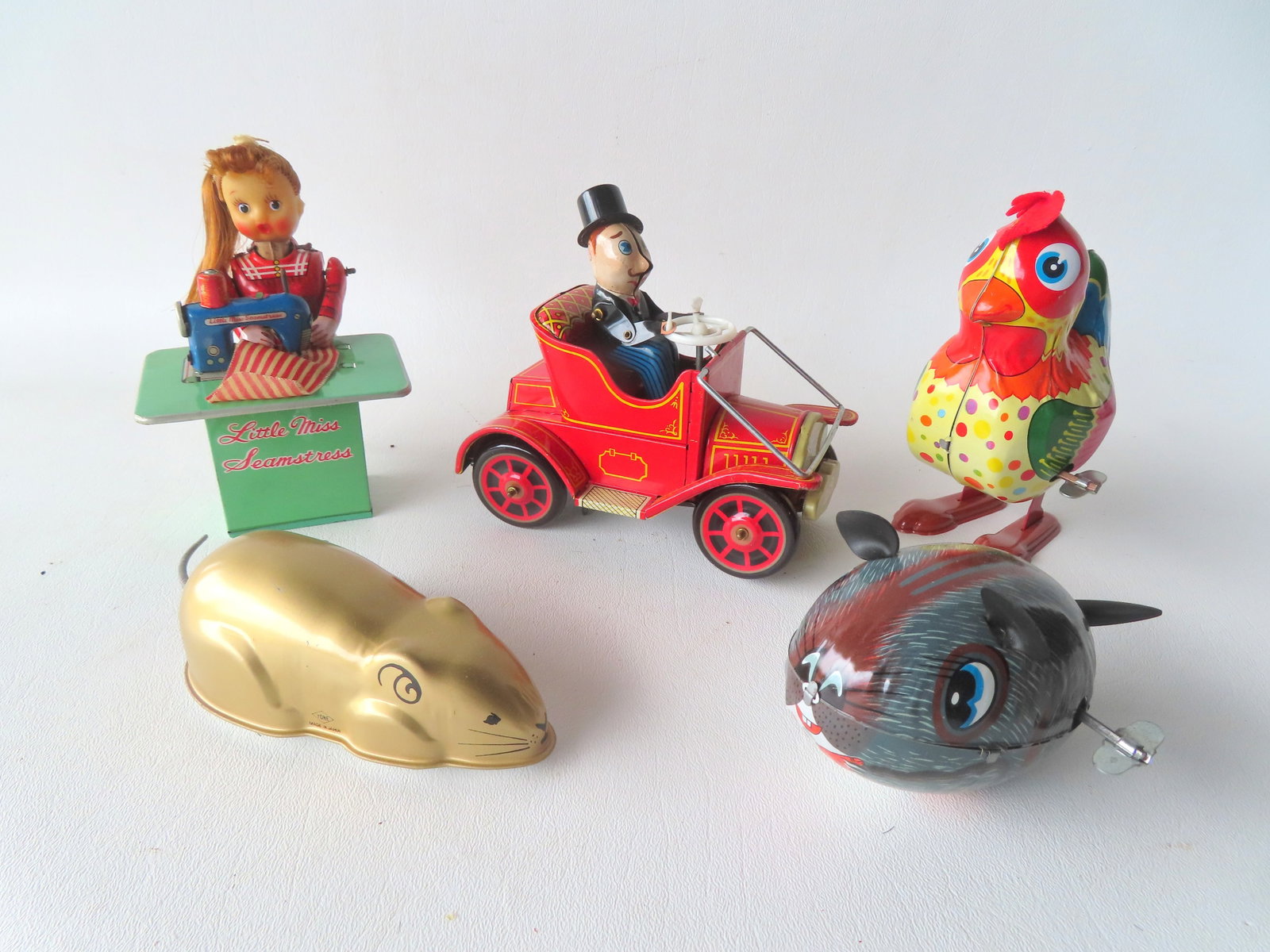 Grouping of 5 Japanese articulated lithographed tin windup toys, including: Mystery action Model T (1 of 2)