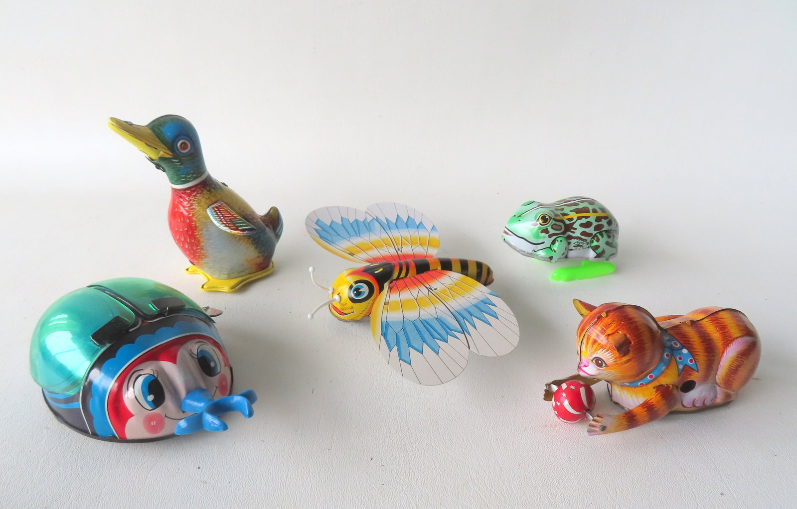 Grouping of 5 Japanese articulated lithographed tin windup toys, including beetle, frog, butterfly, (1 of 9)