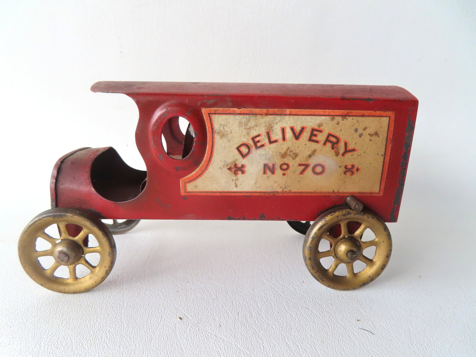 A tin hill climber truck marked "Delivery No. 70", circa 1900-1920. Flywheel in good working order (1 of 5)