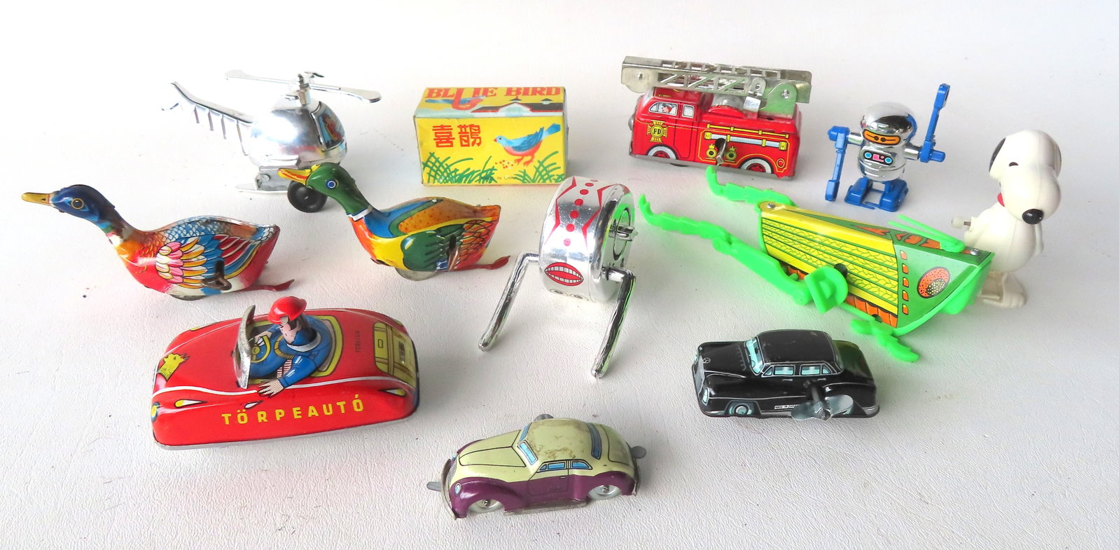 Grouping of 11 small Japanese/Chinese windup toys, some articulated, including: Japan "Torpeaauto" (1 of 6)
