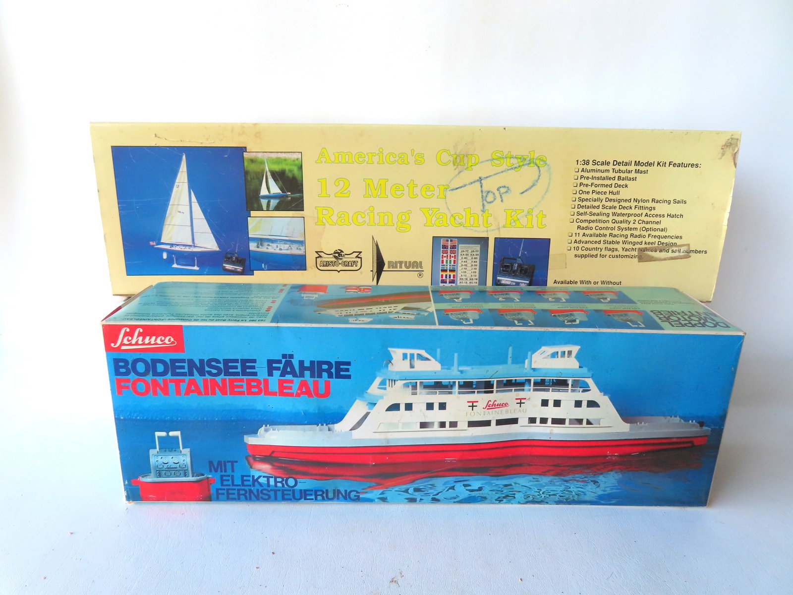 Two remote control boats in original boxes. The first titled "America's Cup Style 12 Meter Racing (1 of 18)
