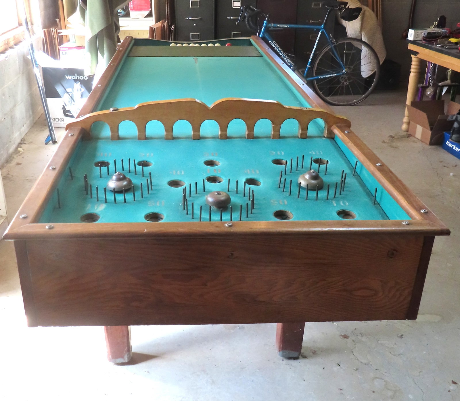 Bagatelle table game, with 9 balls and que sticks. The billiard-like table top is lined with green (1 of 15)