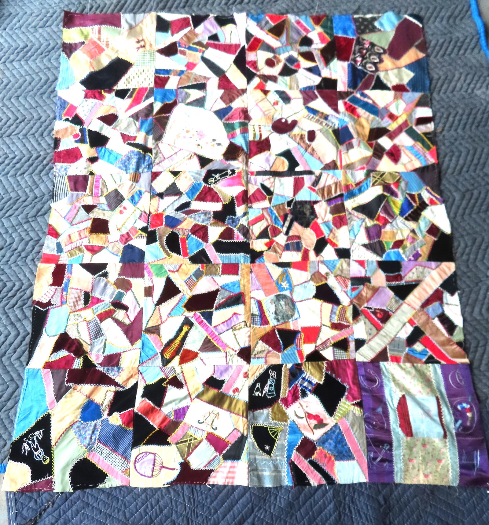 A youth size crazy pictorial quilt, all hand sewn, signed "E.M. 1884 AD". Unfinished border and (1 of 10)