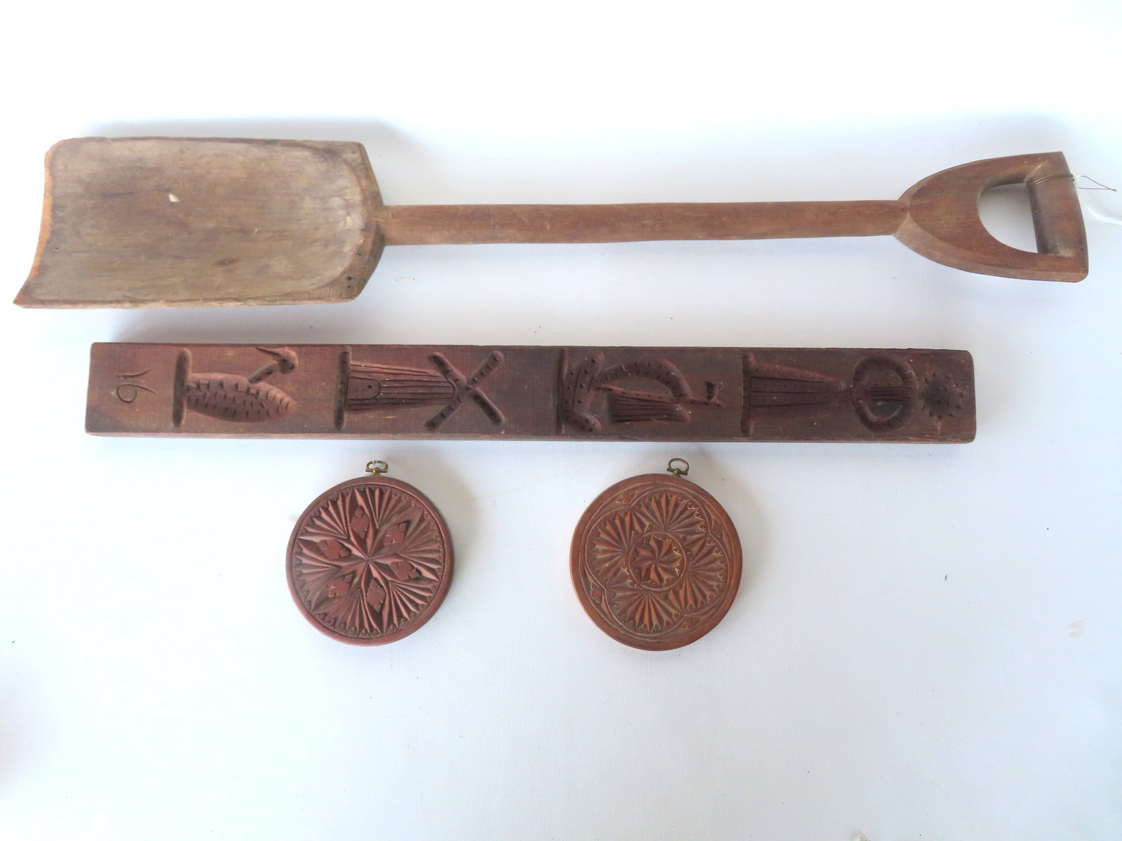 Grouping of 4 pieces of primitive wooden ware including 3 cookie molds and a hand carved grain shove (1 of 14)