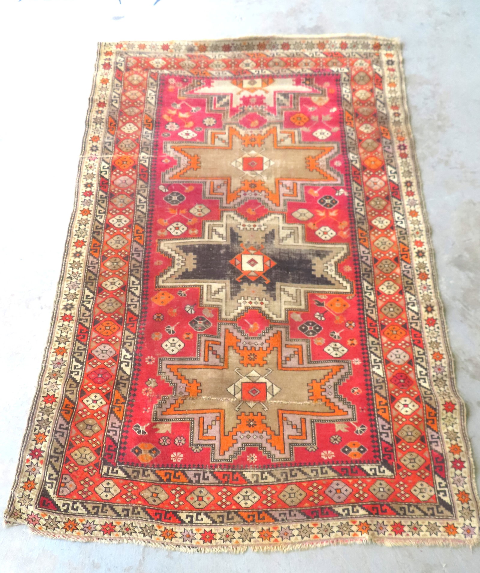 An early oriental scatter rug with use wear and repairs, probably mid 19th century or earlier. Note: (1 of 14)