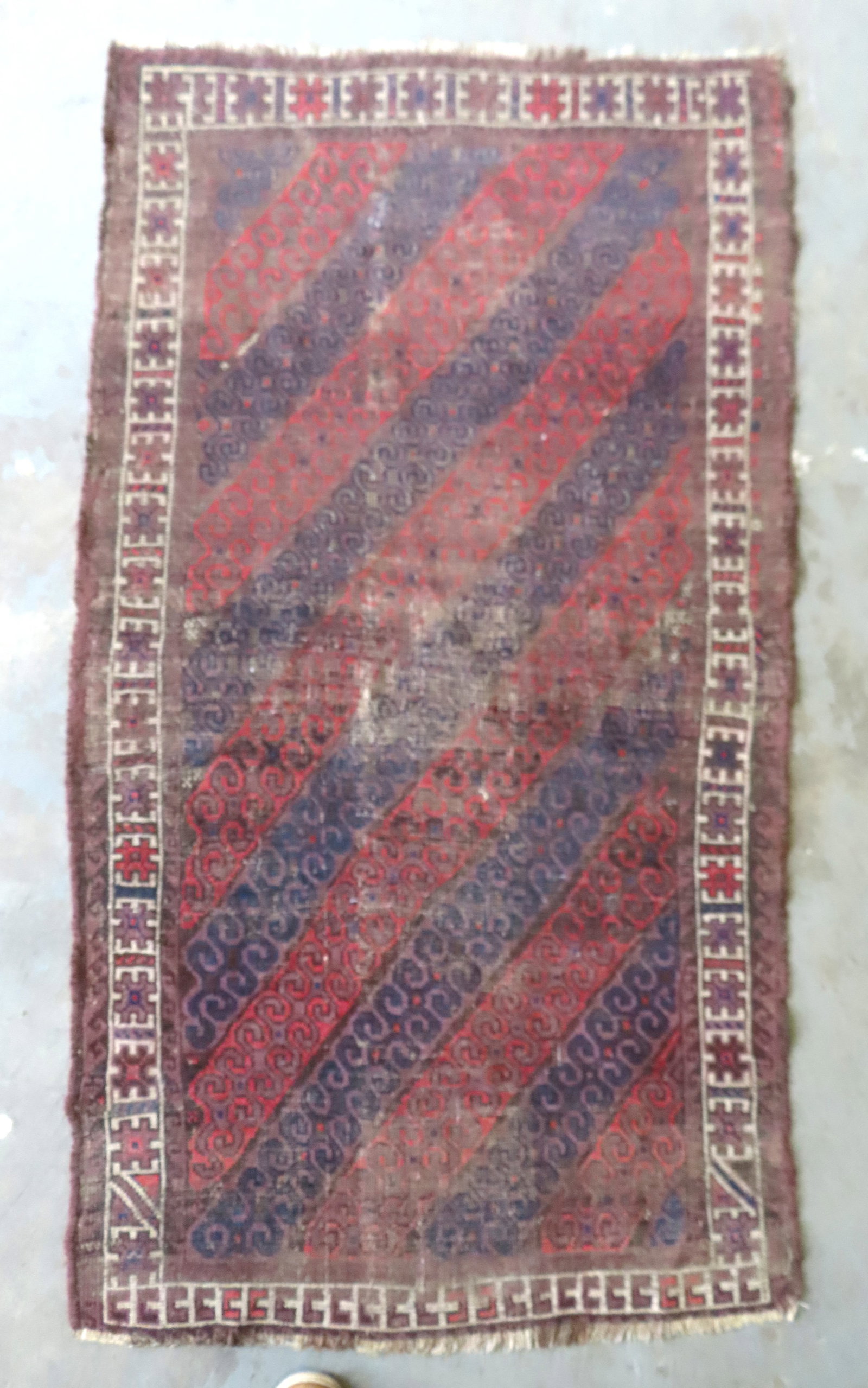 A heavily worn oriental scatter rug, 19th century. Measures 36" x 65". Provenance: Attic found, from (1 of 9)
