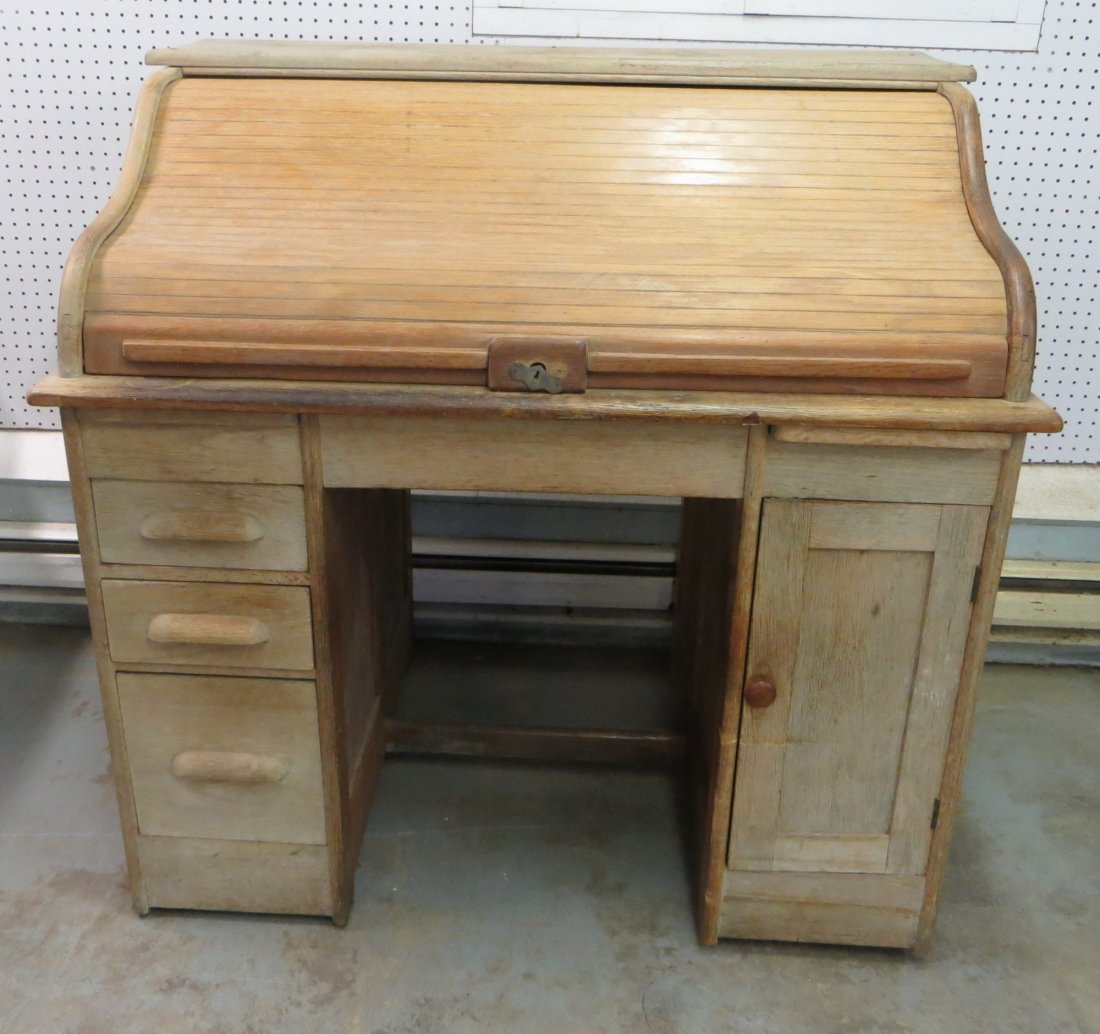 Oak 'S' roll top desk having paneled sides, 3 side draw: Oak 'S' roll top desk having paneled sides, 3 side drawers and 1 door. Late 19th to early 20th century. 44"L.