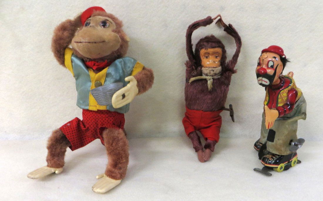 Three windup tin toys including acrobatic monkey, clown: Three windup tin toys including acrobatic monkey, clown and monkey with cup. Clown toy - winds up and runs a little jerky, perhaps needs lubrication. Monkey without the hat - winds up and arms move. M