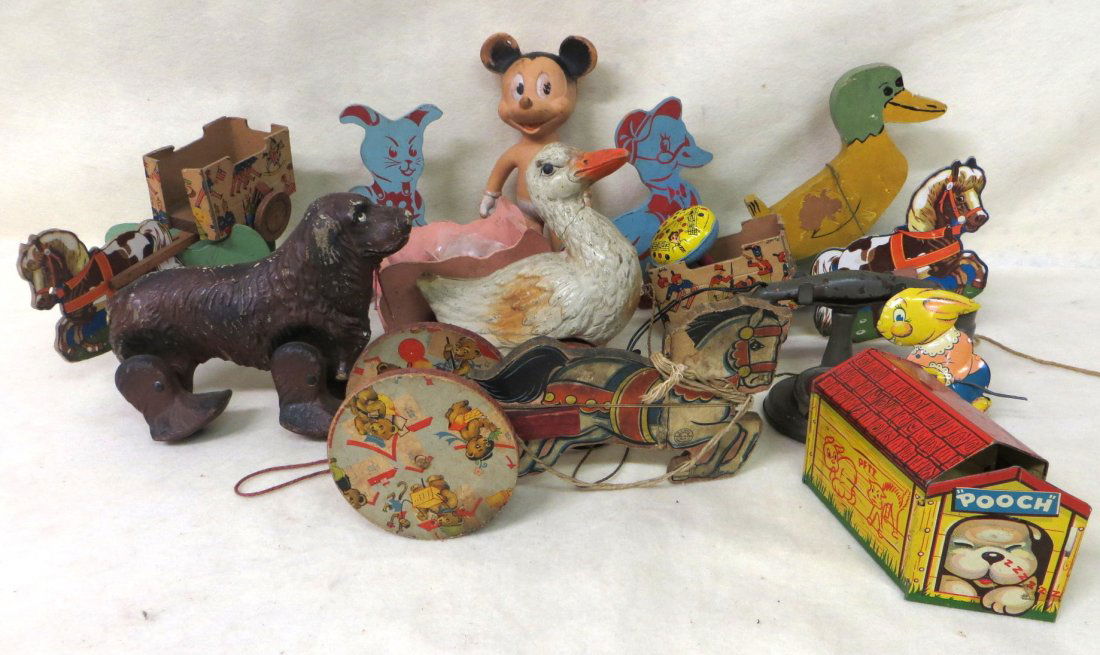 Collection of miscellaneous toys including rubber Micke: Collection of miscellaneous toys including rubber Mickey Mouse, wooden animal pull toys, composition walking duck, lithographed Pouch Pop Out Pup dog house (missing dog), etc.