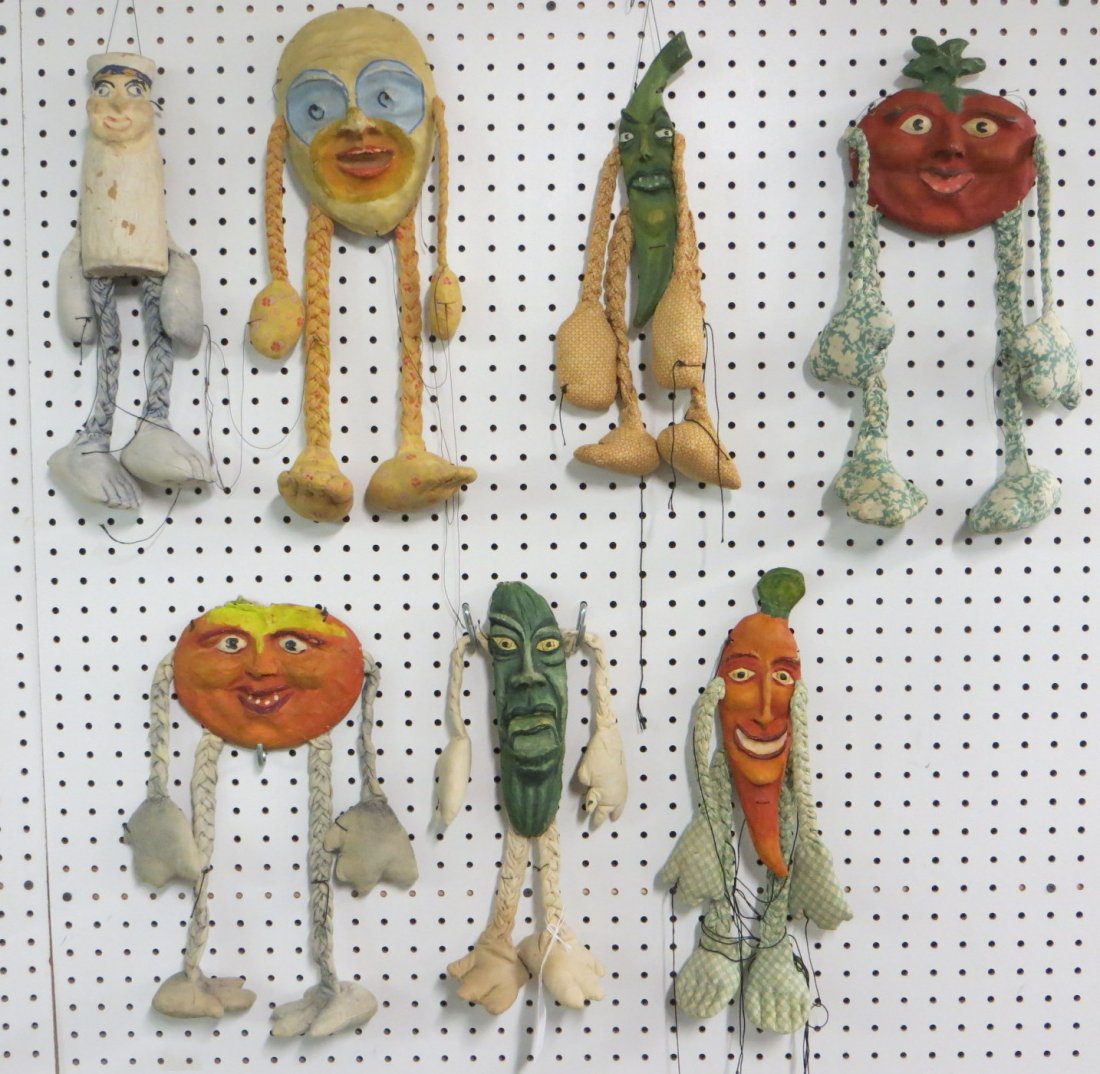 An unusual collection of 7 paper mache vegetable shaped: An unusual collection of 7 paper mache vegetable shaped figural puppets with braided arms and legs including pumpkin, carrot, pepper, etc. Hand painted whimsical faces. Missing strings. Early 20th cen