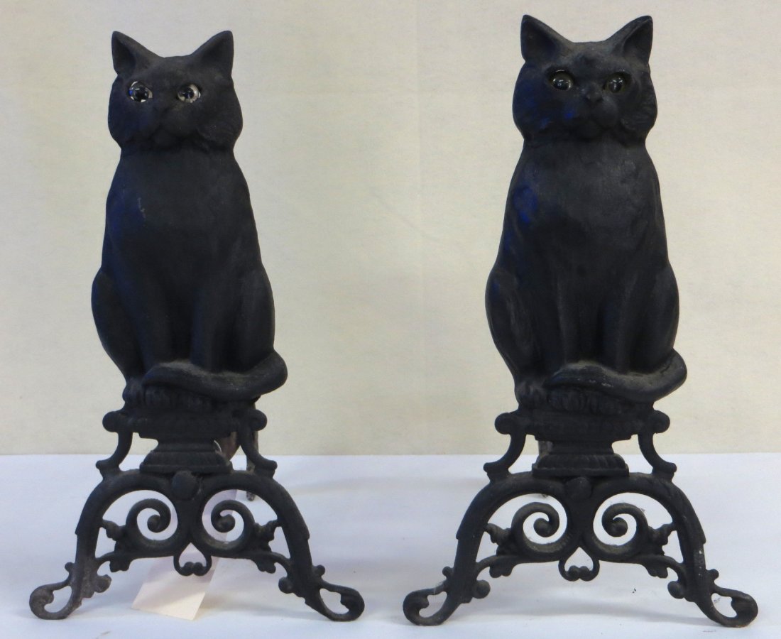 Cast iron seated cat andirons with glass eyes: Cast iron seated cat andirons with glass eyes and ornate reticulated base - log holders mortised thru base - probably late 19th century - note that 1 cat possibly with replaced eye as are a lighter co
