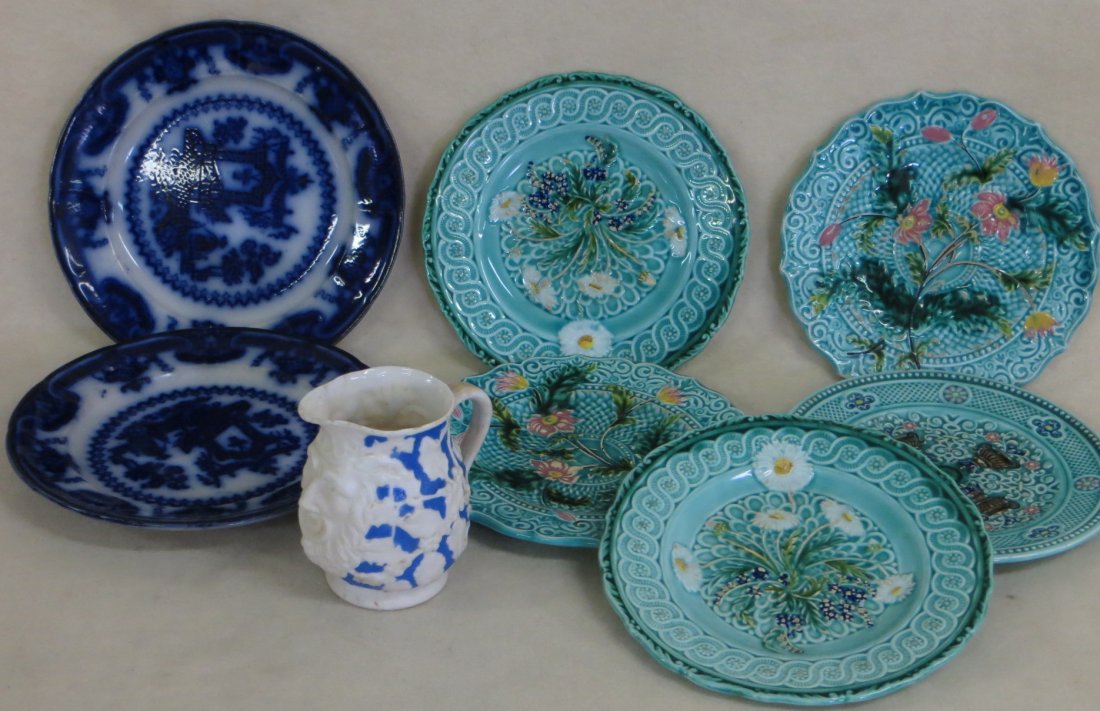 Collection of 8 pieces of china/porcelain including 2: Collection of 8 pieces of china/porcelain including 2 flow blue plates, 5 majolica plates, 1 English parian creamer with embossed Northwind face (tiny chip on spout).