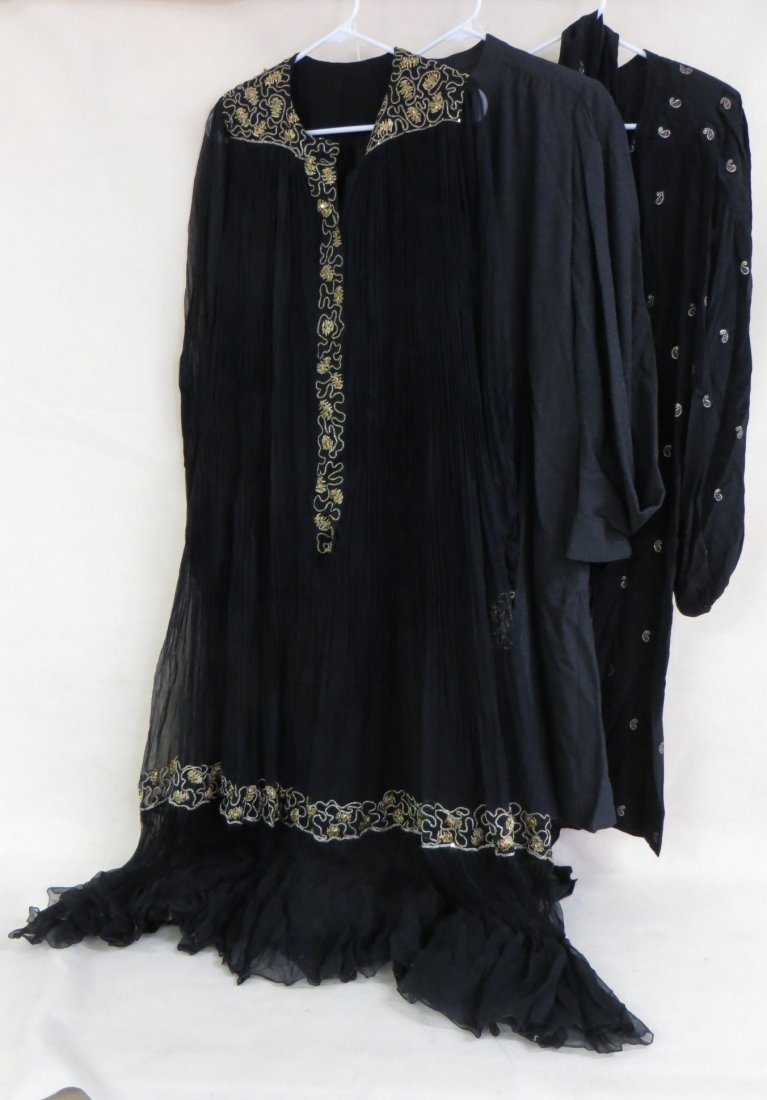 A lot of three custom made dresses approx. sized 10 one: A lot of three custom made dresses approx. sized 10 one a black chiffon with gold adornments, a simple wool dress with a satin liner, and a black silk outfit with multi colored teardrops and a matchin