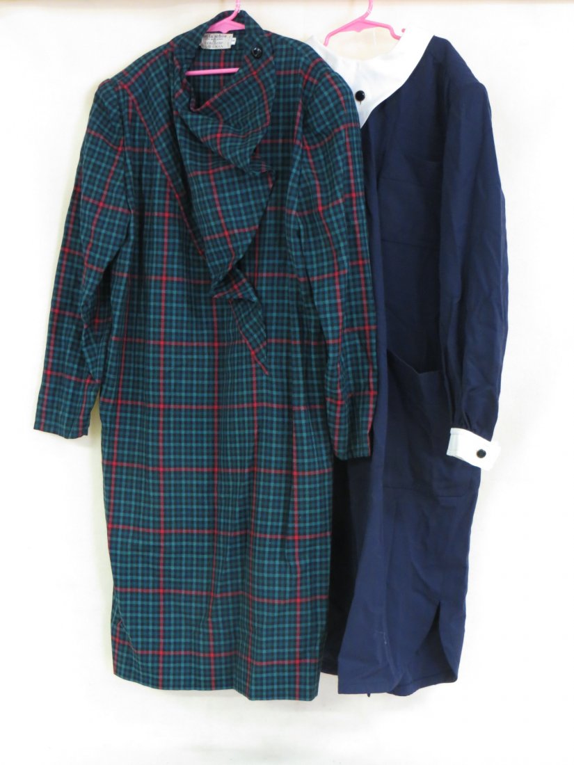 A lot of two designer dresses from Mila Schon in 100%: A lot of two designer dresses from Mila Schon in 100% wool sized 8 one in blue with a white collar and cuffs, the other in a green plaid print with a buttoned collar. Both have the Bergdorf Goodman la