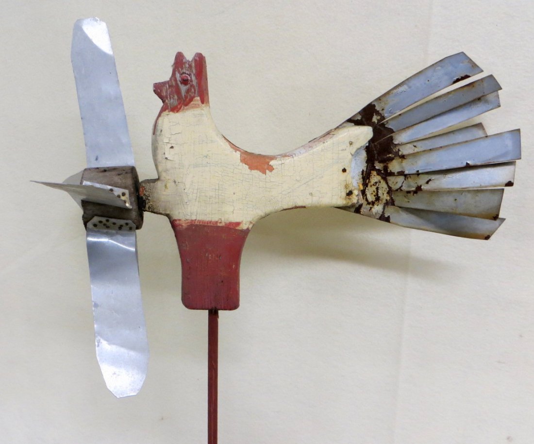 Folk art wooden chicken whirligig in original red and: Folk art wooden chicken whirligig in original red and white paint - aluminum tail feathers and propeller - early to mid-20th century. 13"H x 16.5"L.