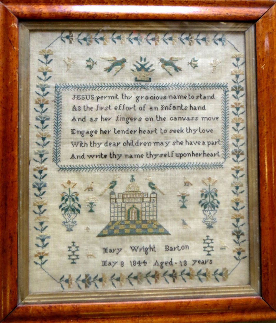 Motto sampler depicting a central large building with: Motto sampler depicting a central large building with birds, flanked by flowers in urns - floral border - signed Mary Wright Barton may 8 1844 Aged 13 years - framed in period birdseye maple frame - e