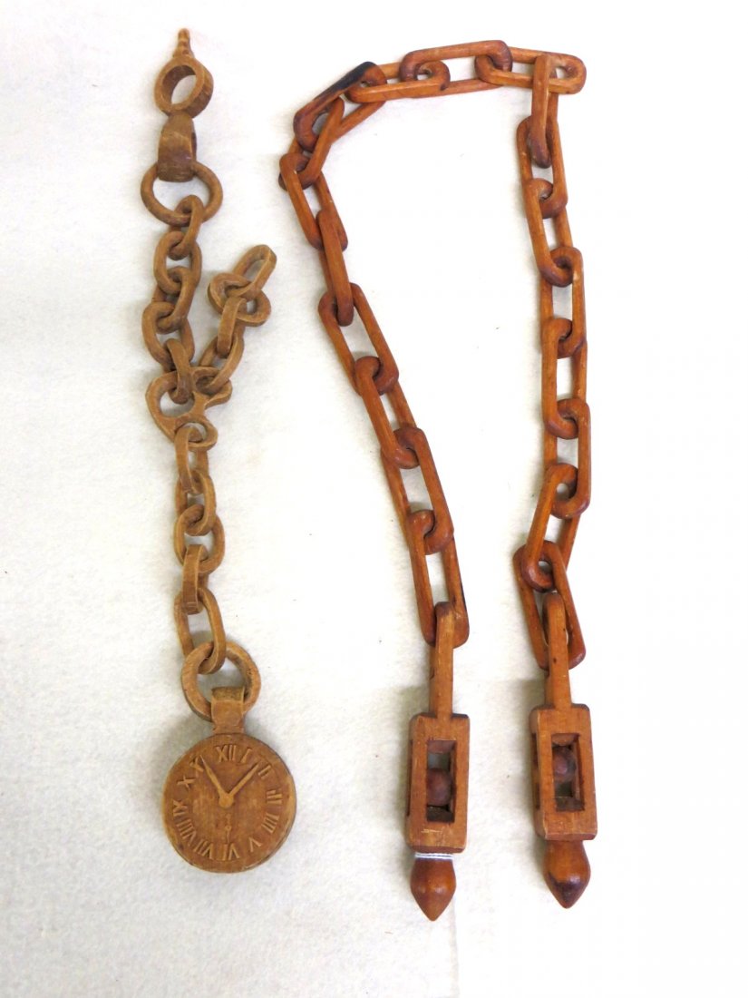 Two folk art hand carved chains (from one piece of: Two folk art hand carved chains (from one piece of wood) including watch fob with key and watch together with a 39"chain with ball encased in open box on each end. 19th century. From a private NY coll