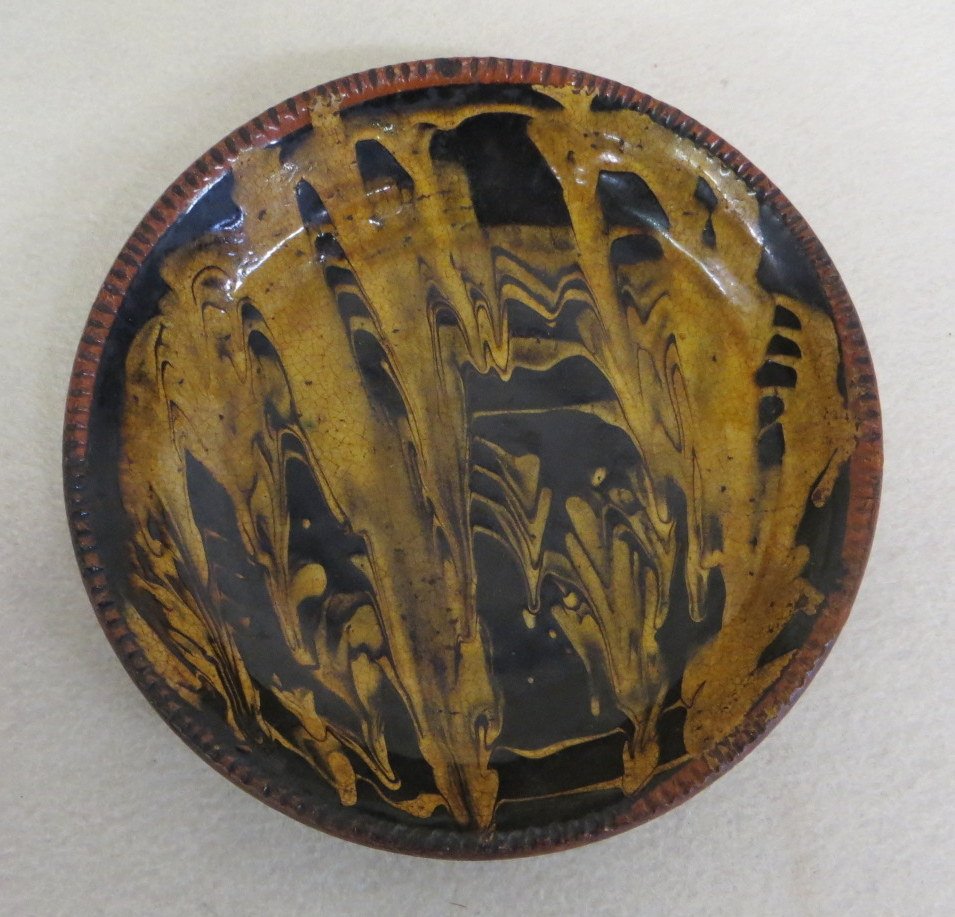 Redware plate with black and yellow slip decoration,: Redware plate with black and yellow slip decoration, crimped edge - 7.5"D - Good condition.