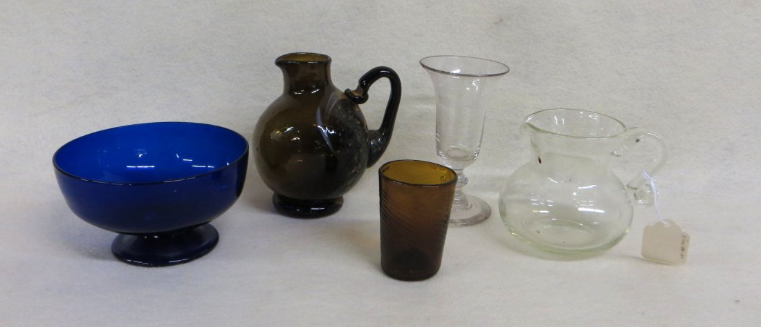 Five pieces of early hand blown glass including 2 small: Five pieces of early hand blown glass including 2 small glass pitchers, blue footed bowl, swirled amber shot glass, wine glass with flared rim. All 19th century or earlier - size range 2.75"H to 4.5"H