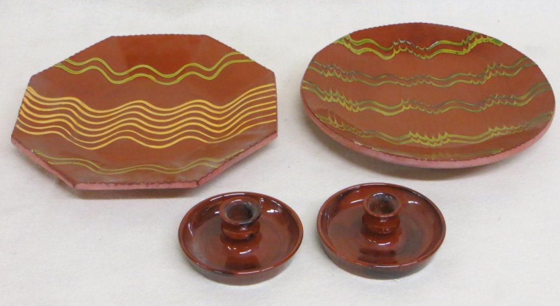 Four Redware items signed L. Breinninger including 2: Four Redware items signed L. Breinninger including 2 candlesticks dated 1984, a 10.5" charger with slip decoration and crimped edge "Sunny but Cold" May 14, 1993, and an octagonal 11" charger with sli