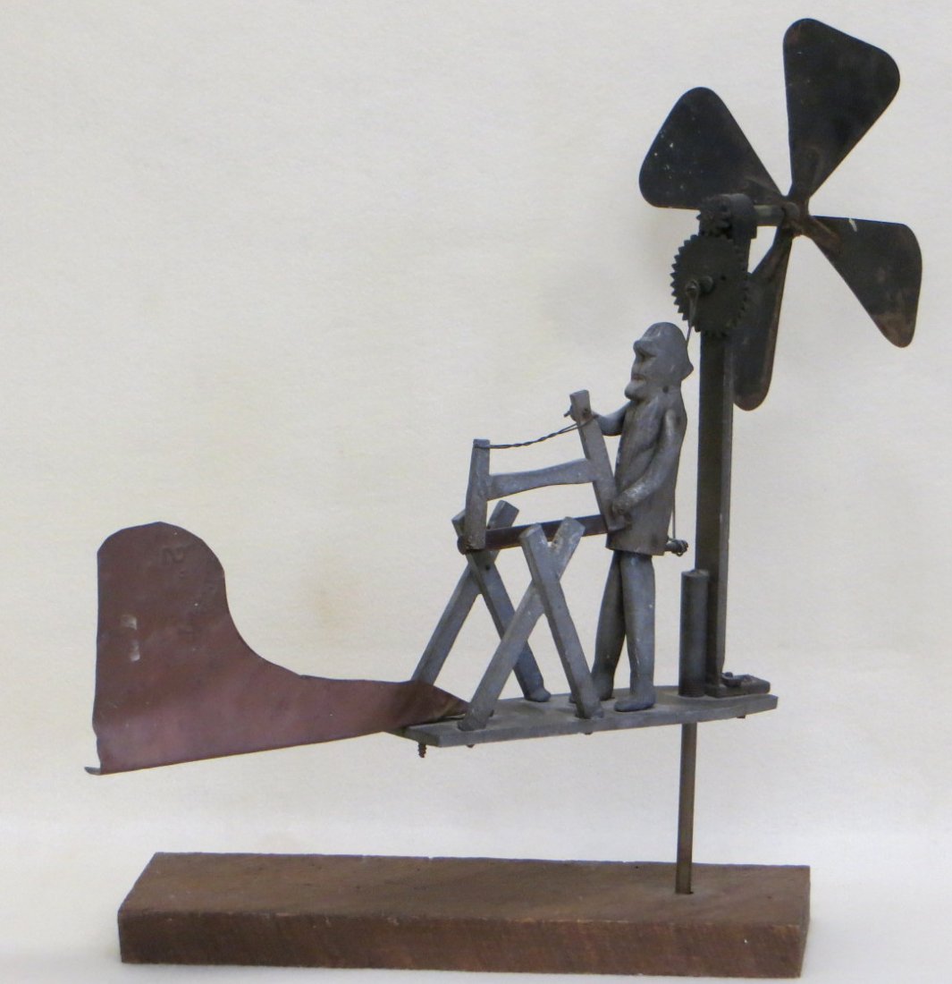 Folk art whirligig of man sawing log. 18"L x 17"H.: Folk art whirligig of man sawing log. 18"L x 17"H.