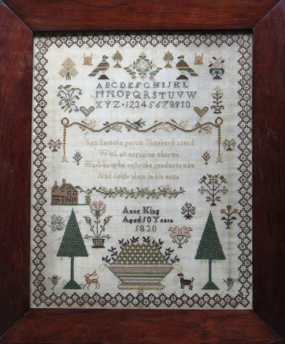 Beautiful alphabet and motto sampler decorated with: Beautiful alphabet and motto sampler decorated with birds, trees, hearts house, various animals and a large basket of flowers - signed Anne King - Aged 10 Years 1830. Very good overall condition - 12.