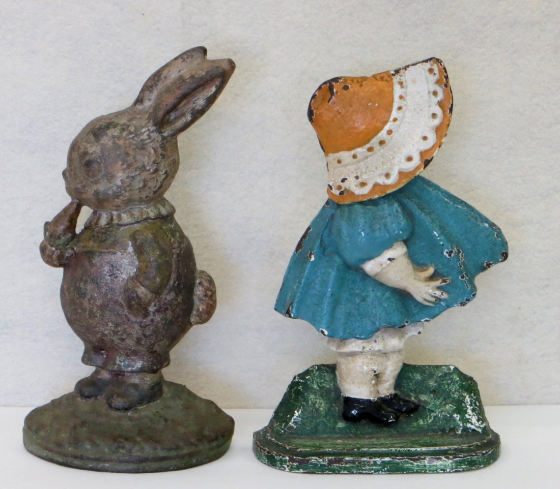 Two cast iron door stops including Peter Rabbit: Two cast iron door stops including Hubley Peter Rabbit eating carrot & Sunbonnet Baby - both 9"H.