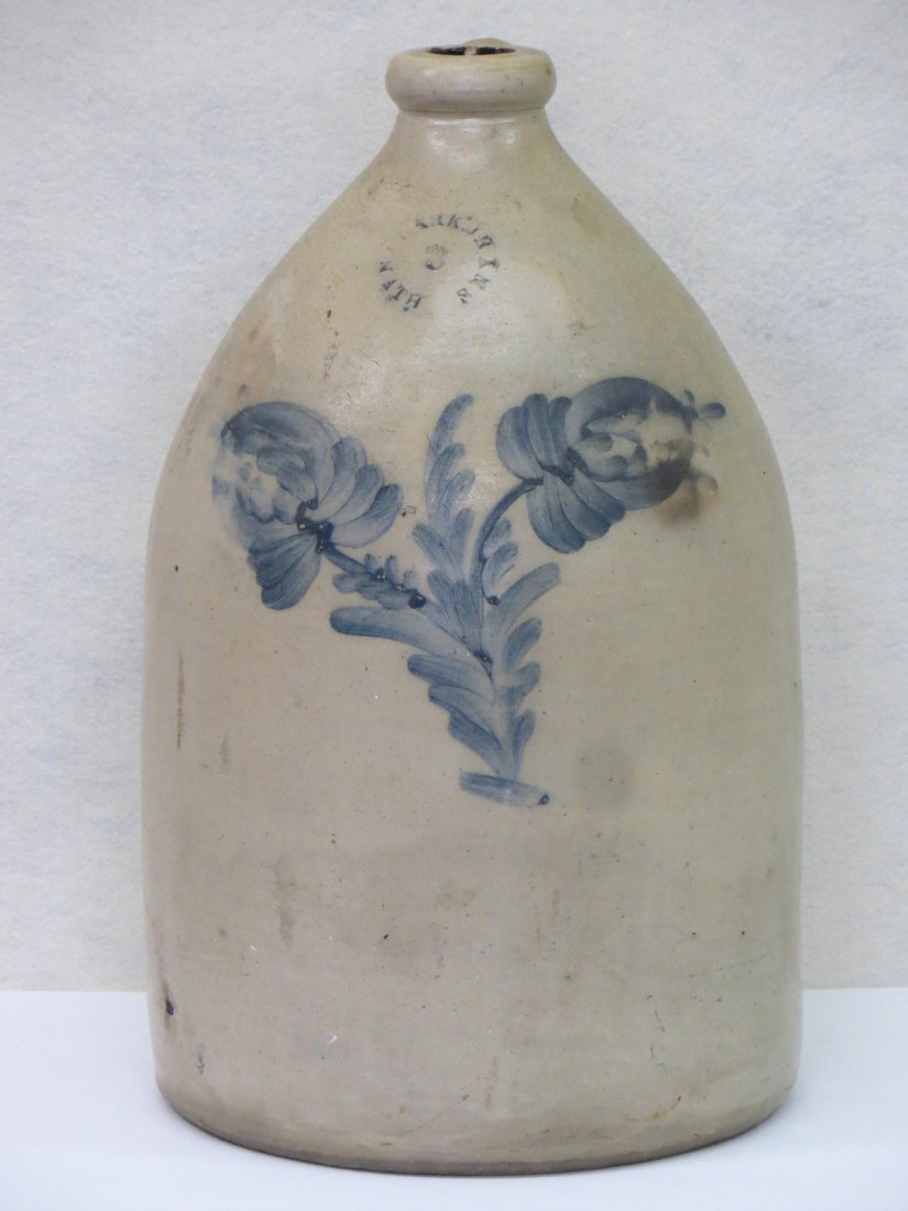 Three gallon stoneware jug with a cobalt blue double: Three gallon stoneware jug with a cobalt blue double flower design stamped N. CLARK, JR ATHenS NY - small hole adjacent to handle approximately 1/4" x 3/4" oval otherwise good condition.