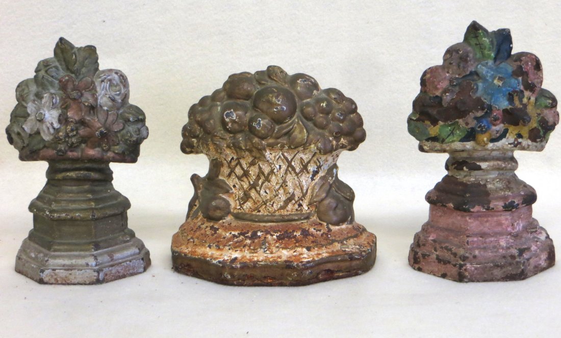 Three cast iron doorstops including two flowers in urns: Three cast iron doorstops including two flowers in urns on a base and one flowers in a basket range 5" to 6.125" H.