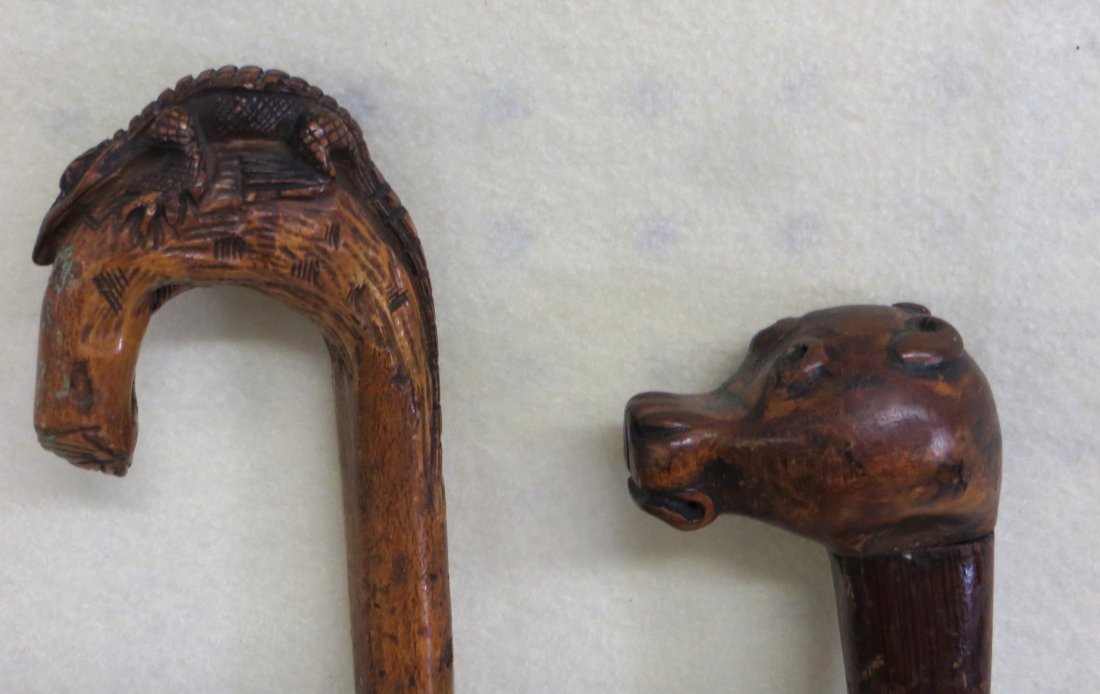 Two folk art canes including one with alligator or: Two folk art canes including one with alligator or lizard handle the other with a carved dog head - both late 19th century.
