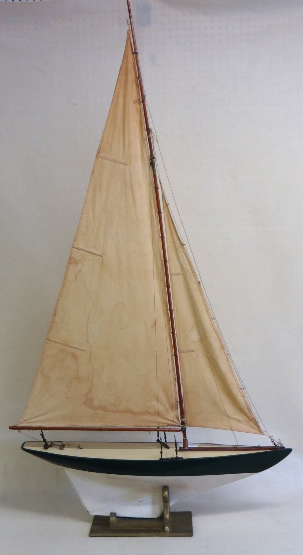 Fully rigged sailing pond boat model in original green: Fully rigged sailing pond boat model in original green and cream colored paint - original cotton sails with some staining, repair to lower end of Hull. Good overall condition - 35.5"L x 65"H.