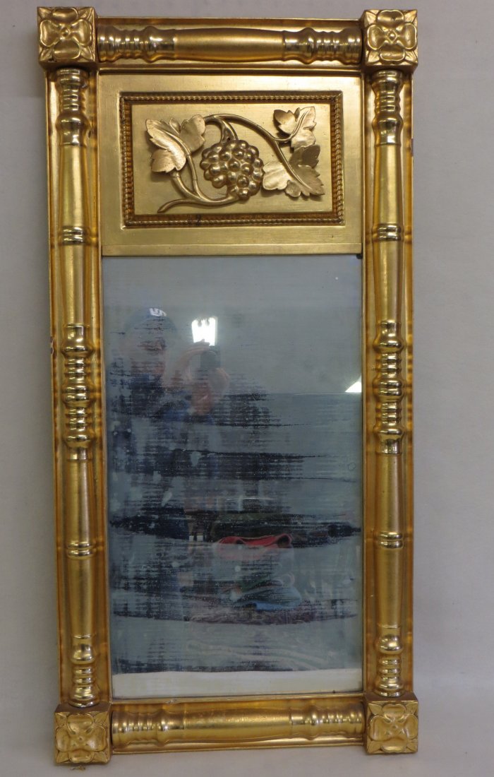 Sheraton double panel gold leaf wall mirror with upper: Sheraton double panel gold leaf wall mirror with upper panel having an embossed design of grapes and leaves - flower decoration adorns each corner. 20.75"W x 42"H.