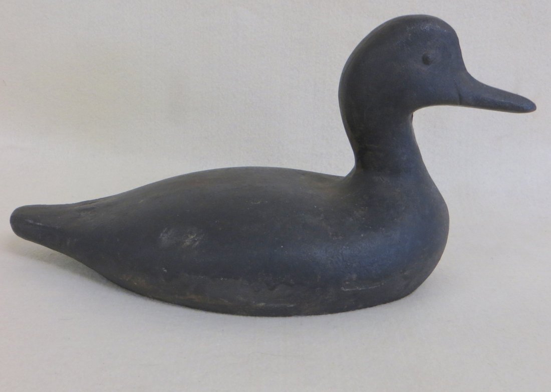 Sink box cast iron decoy with high head, shaped beak: Sink box cast iron decoy with high head, shaped beak and embossed eyes - old label on base identifies bird as Ocracoke Island, NC. 12"L.