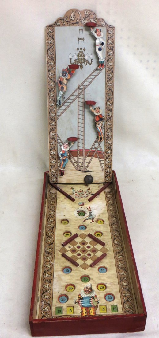 Early child's drop-ball game (precursor to today's: Early child's drop-ball game (precursor to today's pinball games). Game consists of a vertical backboard containing moveable lithographed clowns each with a bucket to catch balls as the drop from top 