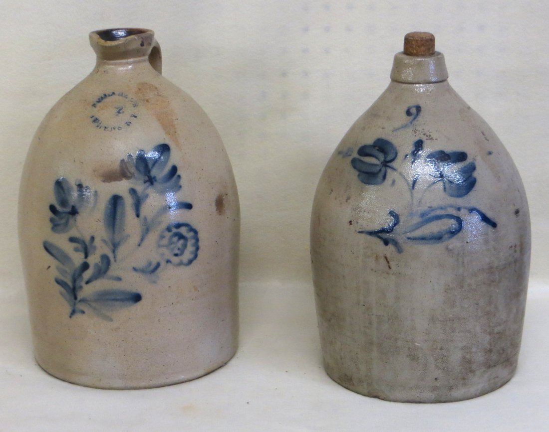 Two stoneware jugs including 2 gallon signed Clark Jr.: Two stoneware jugs including 2 gallon signed Clark Jr. Athens NY decorated with a cobalt blue triple flower - spout with chip, and an unsigned jug with double cobalt blue flower (firing chip on side).