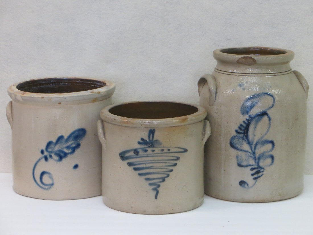 Three stoneware crocks including 1 gallon with cobalt: Three stoneware crocks including 1 gallon with cobalt blue tornado design (hairline in front), 1 1/2 gallon with cobalt leaf design (small hairline and 2 rim chips), and a 2 gallon jar with cobalt blu